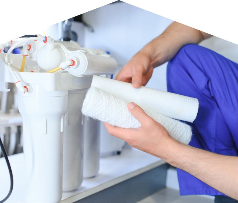 Mr. Furnace water filtration specialist replacing filter cartridges on a reverse osmosis water system installed under a sink. Mr. Furnace water filtration specialist replacing filter cartridges on a reverse osmosis water system installed under a sink.
