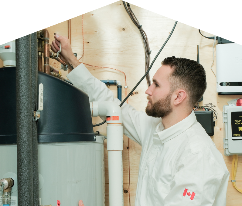 Mr. Furnace water heater specialist adjusts piping on a large residential unit during a repair service, with exposed wood paneling and mounted utility components in the background. Mr. Furnace water heater specialist adjusts piping on a large residential unit during a repair service, with exposed wood paneling and mounted utility components in the background.