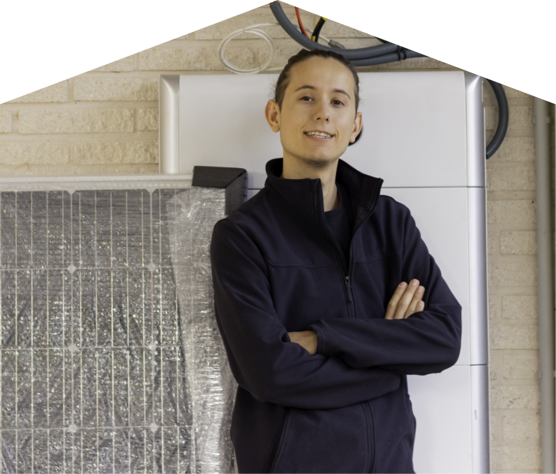 Mr. Furnace specialist standing confidently with arms crossed beside newly delivered system components, including a wrapped panel and wall-mounted utility unit. Mr. Furnace specialist standing confidently with arms crossed beside newly delivered system components, including a wrapped panel and wall-mounted utility unit.