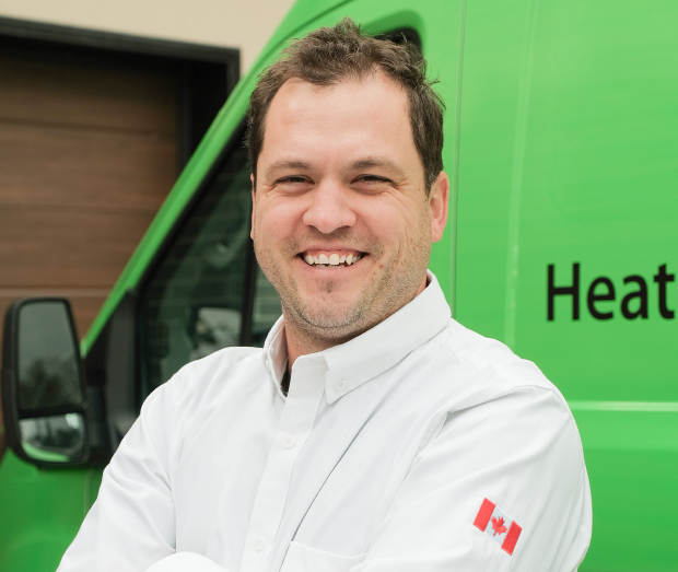 Smiling Mr. Furnace technician standing confidently in front of their green service van, wearing their white issued uniform. Smiling Mr. Furnace technician standing confidently in front of their green service van, wearing their white issued uniform.